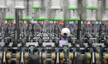 Technician working between knitting machines